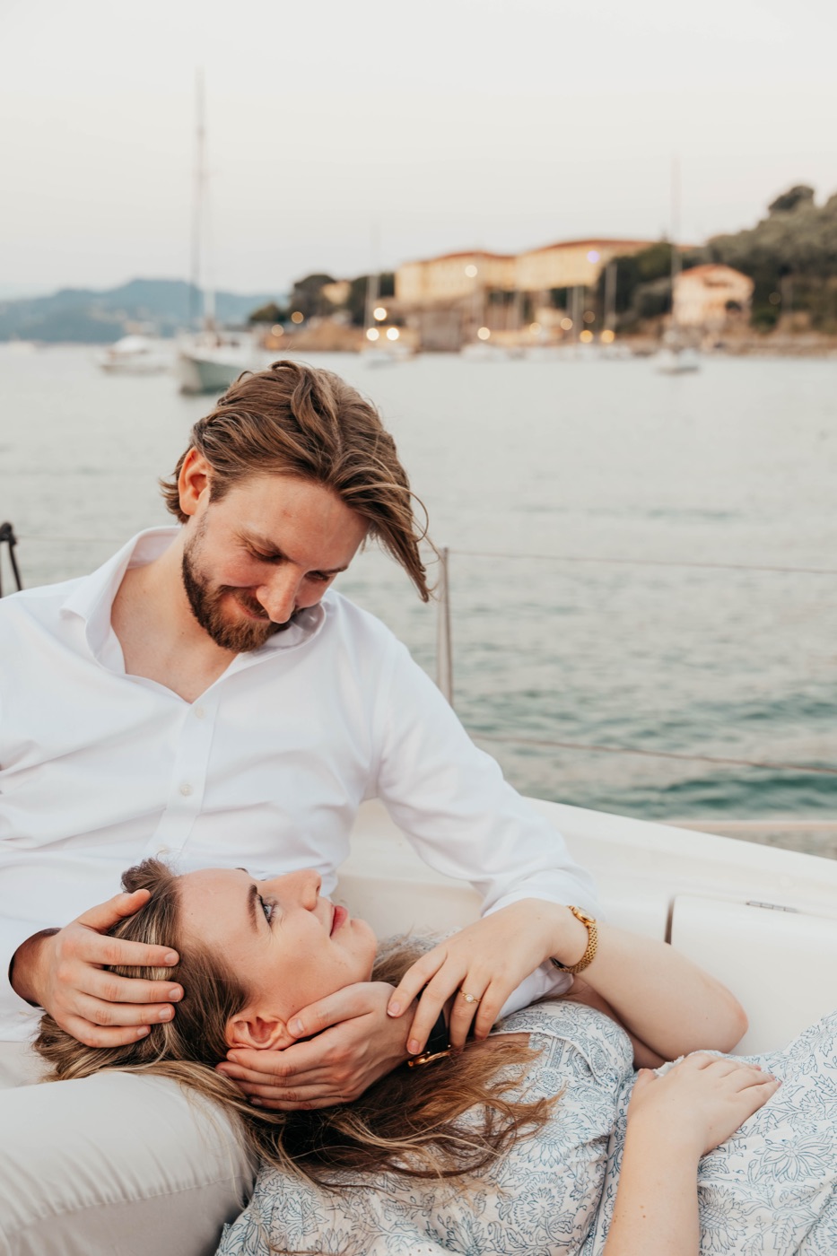 Jess resting in Antonio's arms on deck