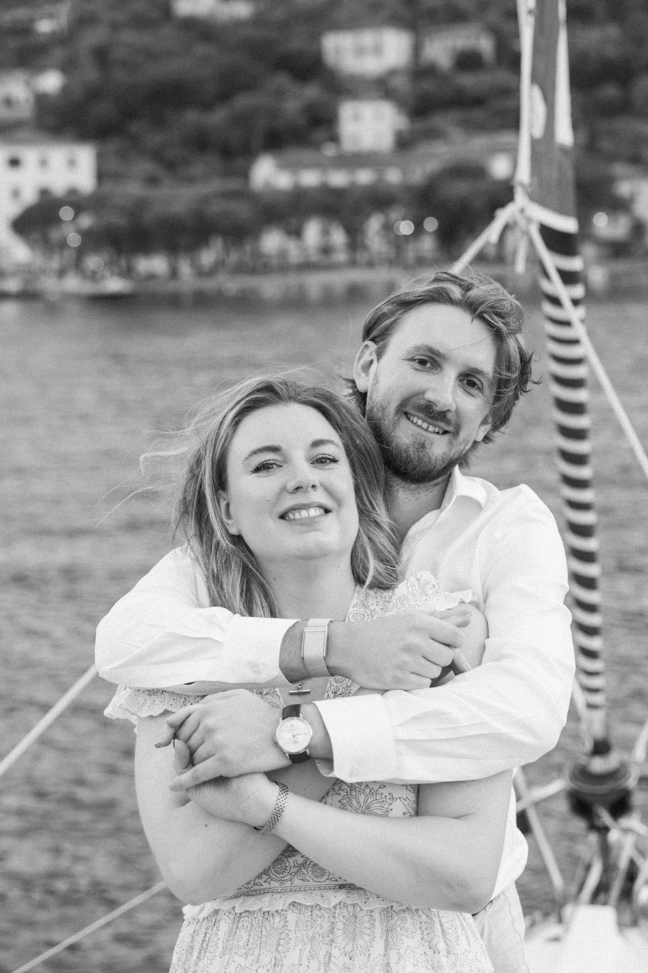 Antonio embracing Jess, both smiling, in black and white