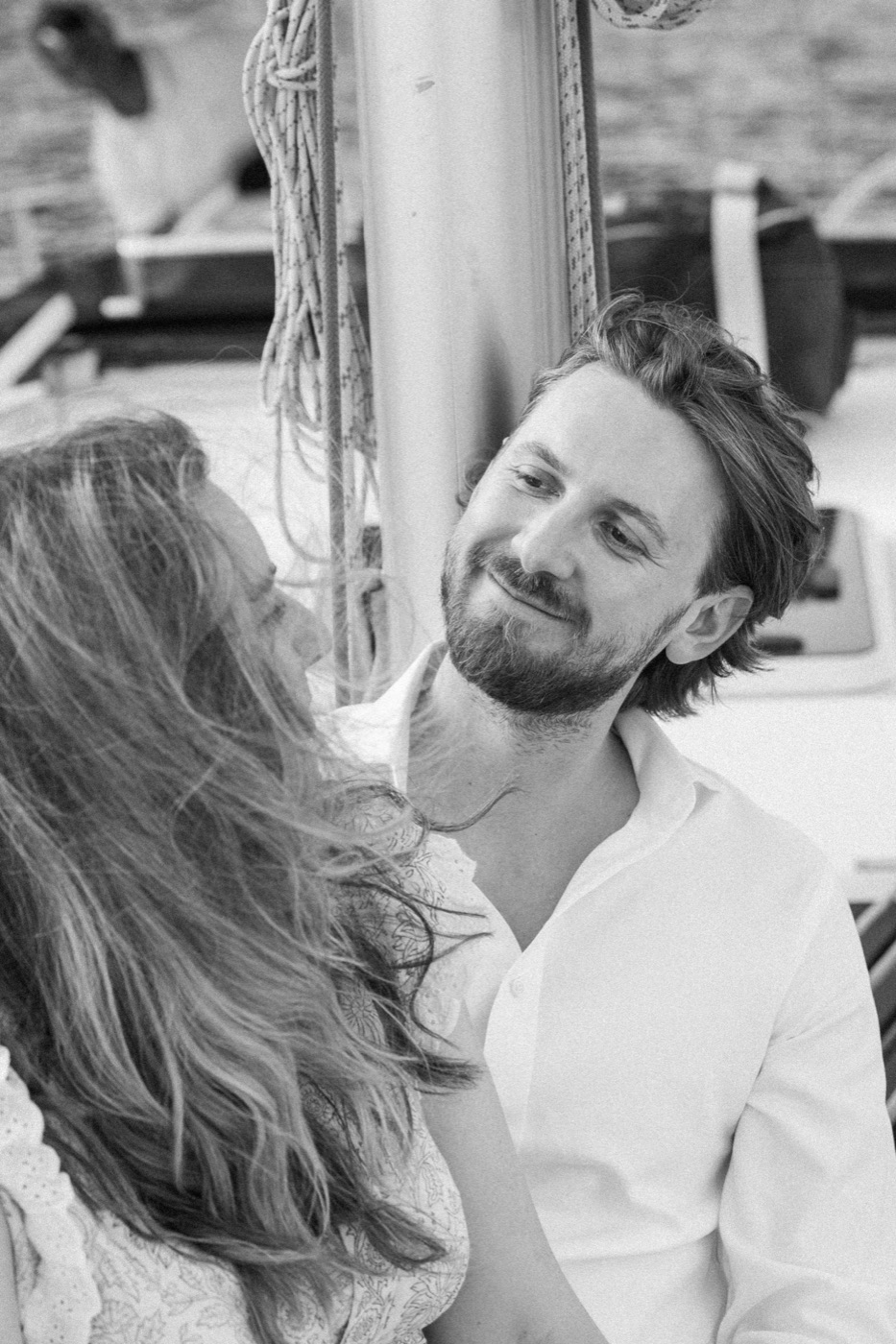 Antonio smiling at Jess, in black and white