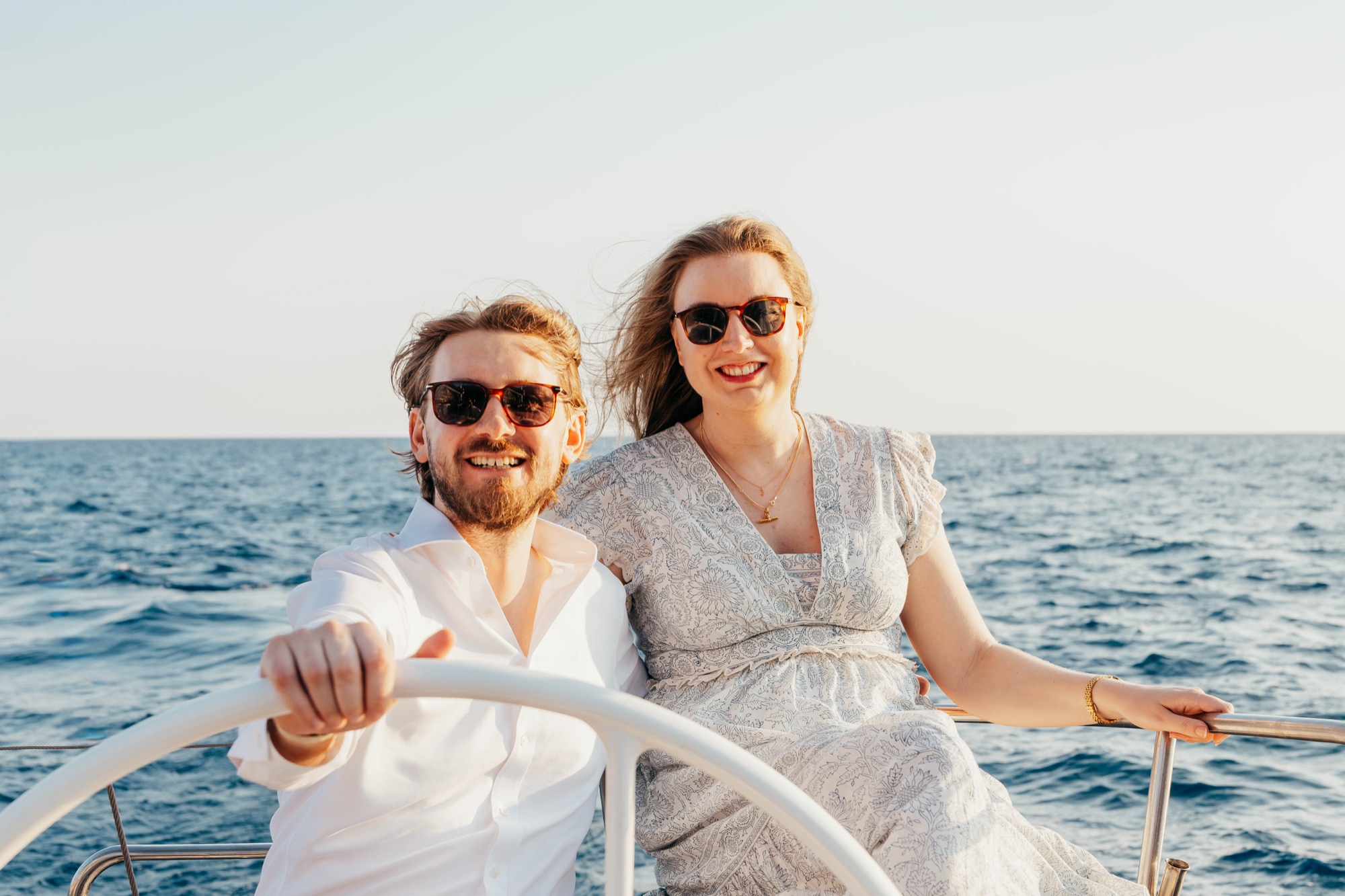 Jess and Antonio at the helm, sailing in the sunshine