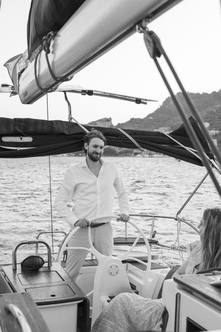 Antonio on deck beneath the boom, in black and white