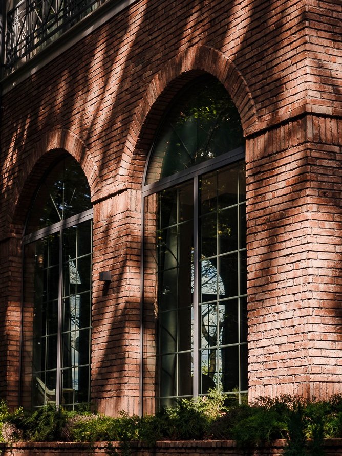 The arched brick windows of Snagov Mansion in evening light